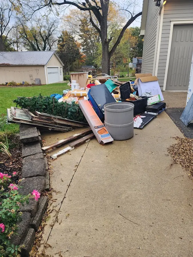 Dumpster being loaded with debris for 10 Yard Dumpster Rental in Eagan